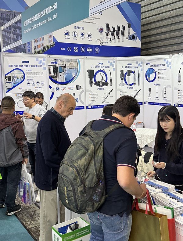 OULD sales and technical team meeting global visitors at an industrial expo